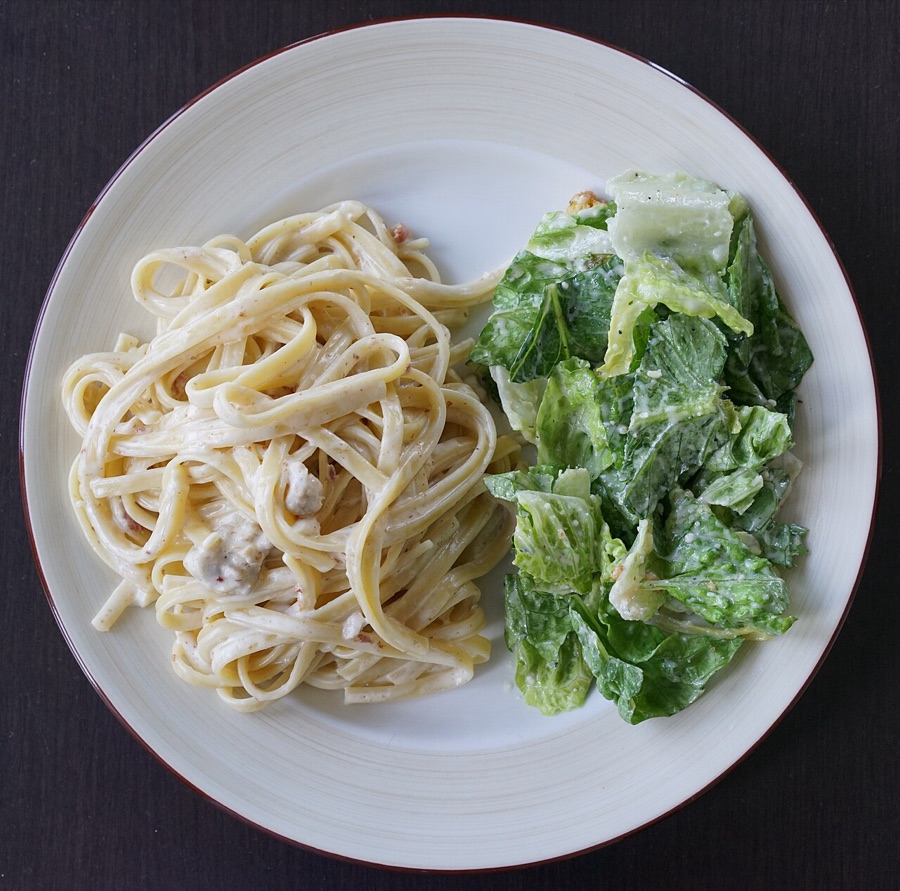 Fettuccine alfredo, creamy ribbons with a green salad